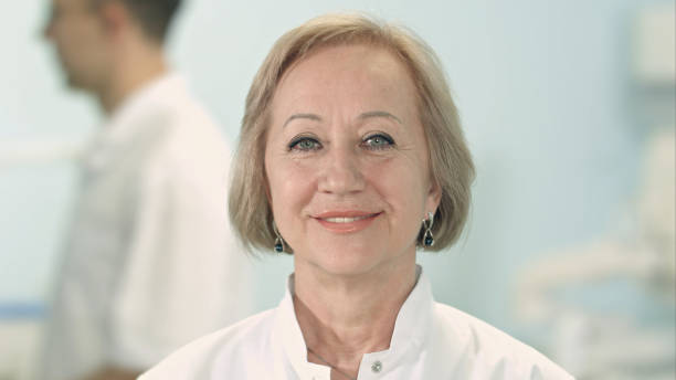 istock Smiling senior female doctor looking at camera 810535996