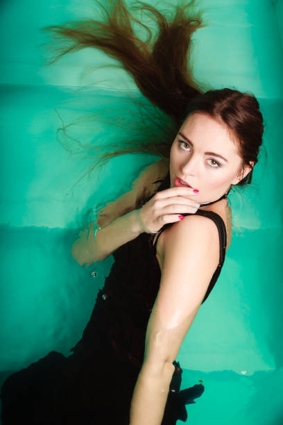 istock Sexy seductive woman in water. 810539036