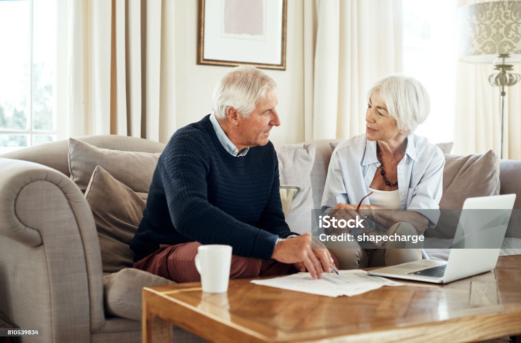 Managing their money through their retirement Shot of a senior couple going through their paperwork together at home Senior Couple Stock Photo
