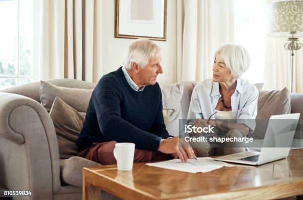 Managing Their Money Through Their Retirement Stock Photo - Download Image Now - Senior Couple, Retirement, Document