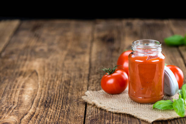 istock Tomato Ketchup (selective focus) on vintage wooden background 810559446