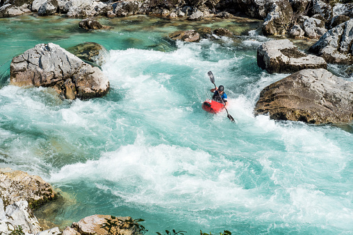 Mature Man Kayaking In White Water Of River Soca