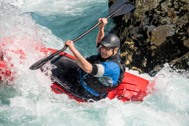 istock Close Up Of Mature Man Kayaking On White Water's 810563768