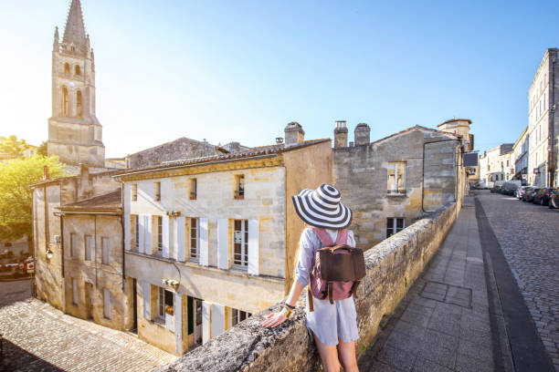 Woman tarveling in Saint Emilion village, France Young woman tourist walking old street at the famous Saint Emilion village in Bordeaux region in France saint emilion photos stock pictures, royalty-free photos & images