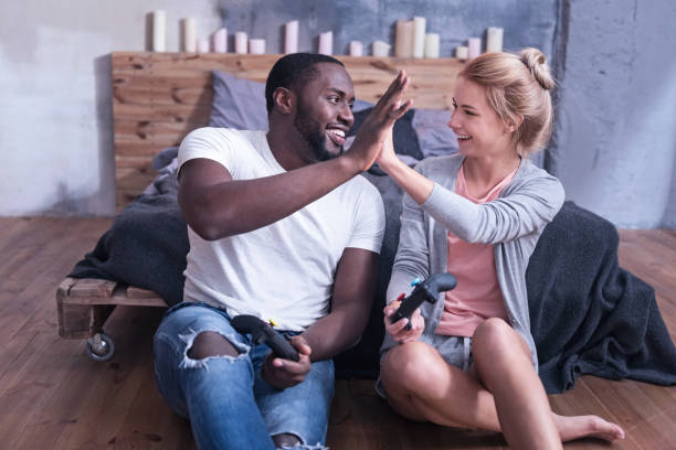 Smiling international couple amusing at home