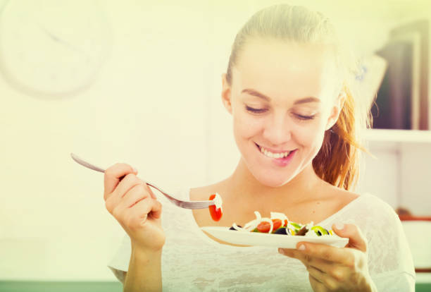 istock girl eating vegetable salad 810564476