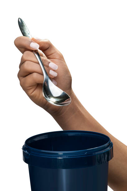 istock Holding spoon for ice cream isolated for advert 810564786