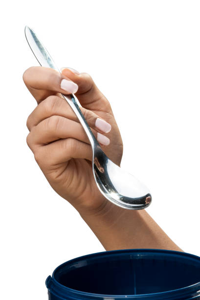 istock Holding spoon for ice cream isolated for advert 810564802