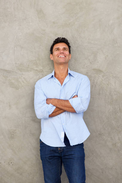 istock happy middle age man looking up and laughing 810567300