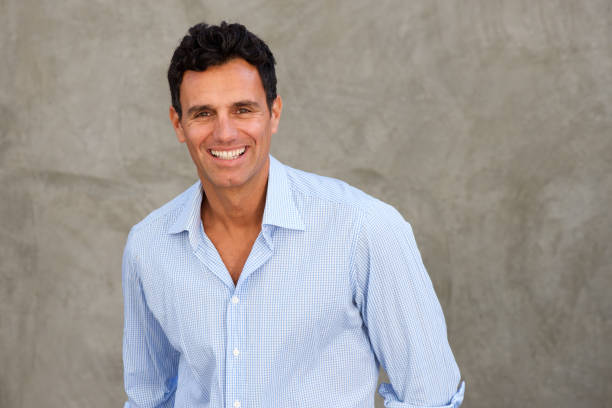 istock smiling businessman standing by wall 810567312