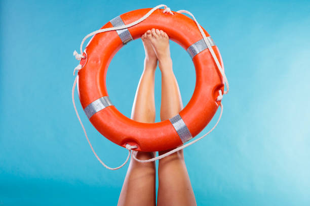 istock Life buoy ring on female legs 810571340