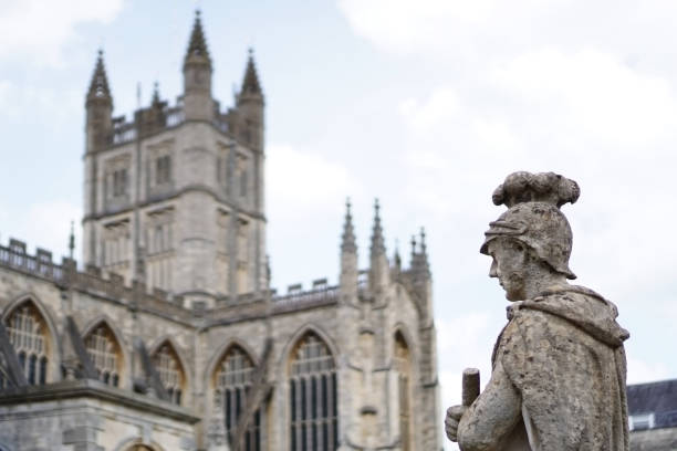 istock Statue at Roman baths with Bath Abbey in background 810571738