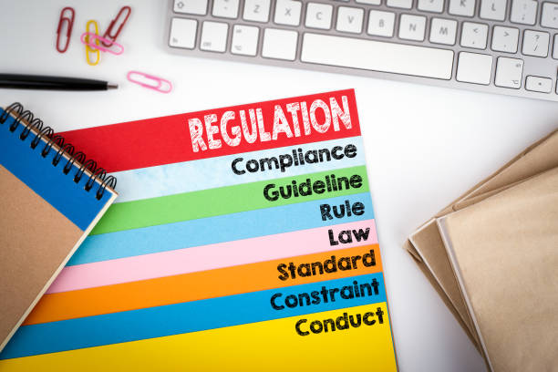 istock Regulation. Office desk with a computer keyboard and color pages 810572110