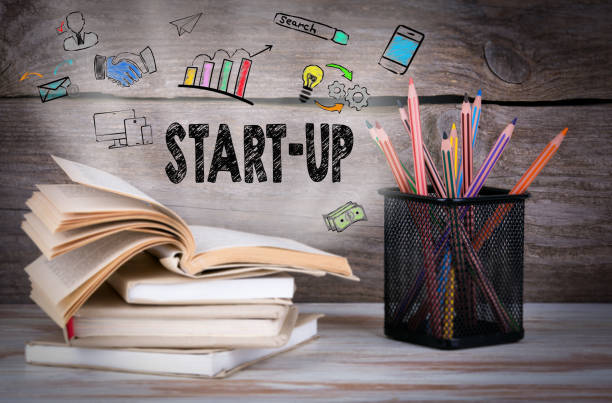 istock Start Up. Stack of books and pencils on the wooden table. 810575736