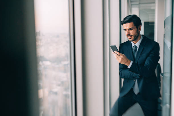 istock Buisnessman Texting On The Phone 810578754