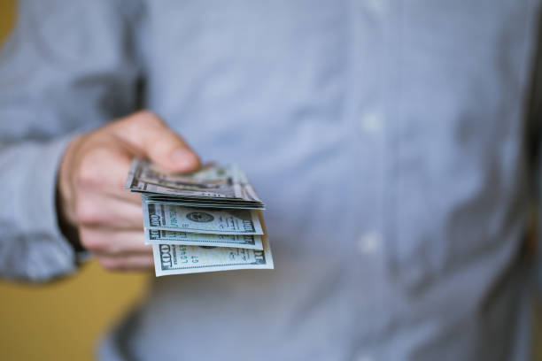 istock Businessman holding money in his hands 810584432