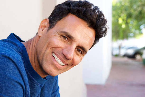 istock Close up attractive mature man smiling 810599084