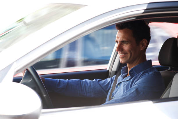 istock smiling man driving in car 810599096