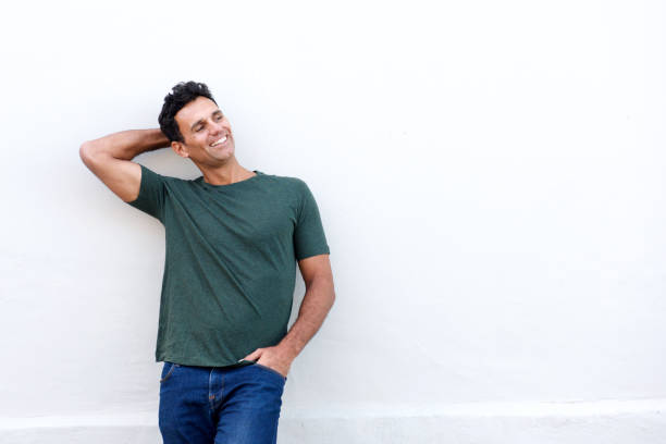 istock handsome middle age man smiling with hand in hair 810599204