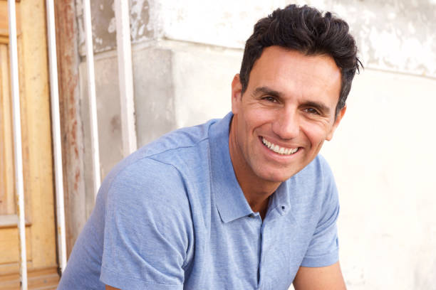 istock Close up handsome man sitting and smiling 810599242