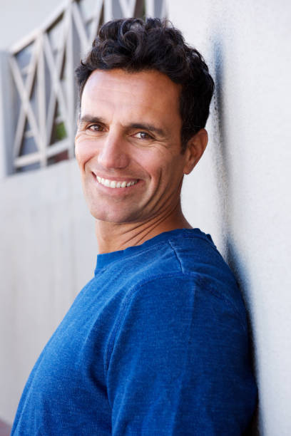 istock Close up side portrait of handsome man smiling 810599260