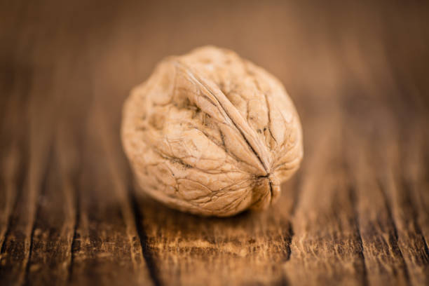 Macro photo of a roasted chestnut on a wooden table