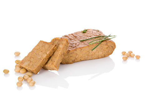 Tempeh isolated on white. Traditional soybean product.