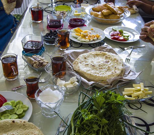 istock Traditional Turkish breakfast table with tea, jam, fresh bread, cheese, green onions, parsley, tomatoes, cucumber pictures 810606058
