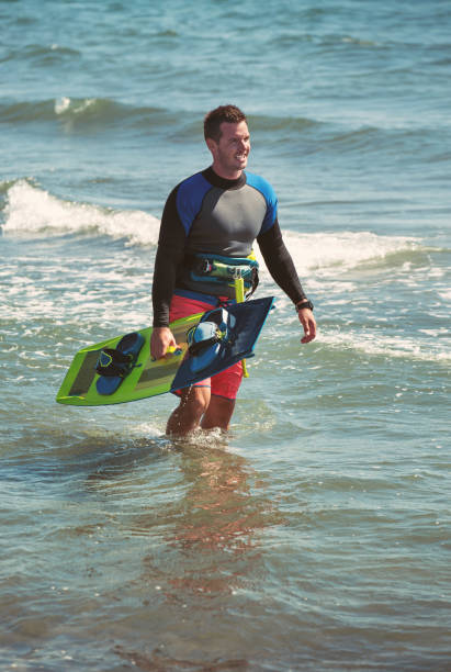 istock Athletic man riding on kite surf board 810613726