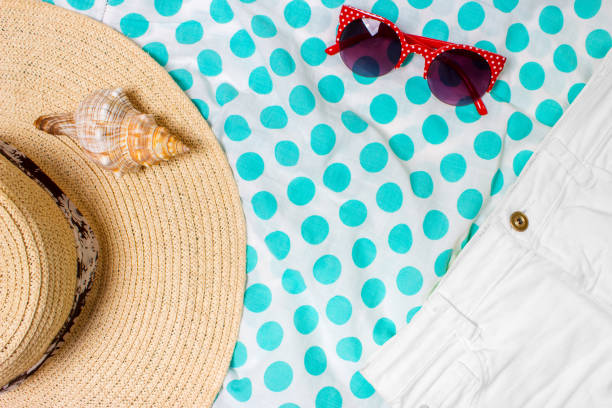 istock Straw Beach Woman's Hat Sun Glasses Top View Seashell Shorts with space for text. 810629320