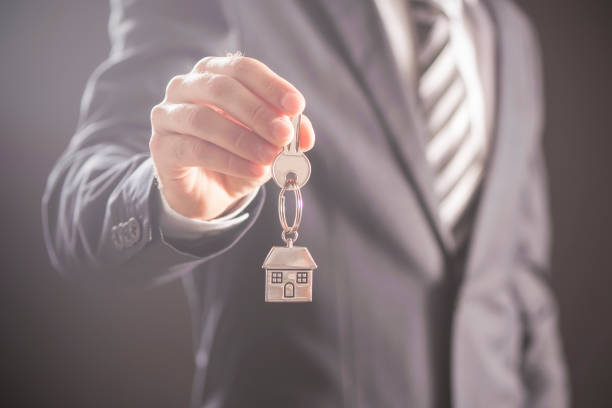 istock Real estate agent handing over house keys 810634932