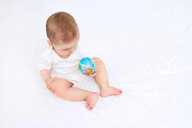 istock Baby and globe. Isolated on white background 810663730