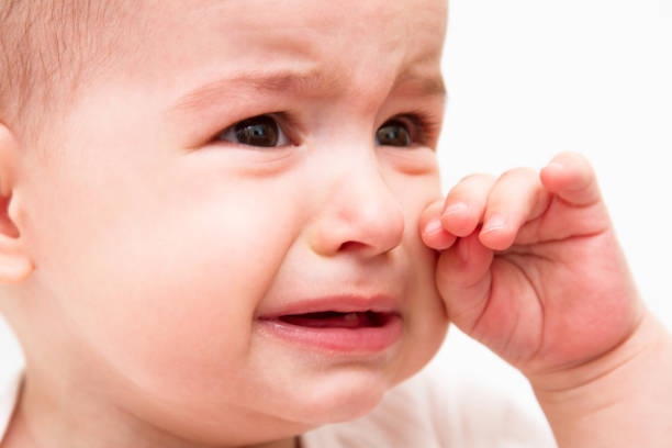 istock Crying beautiful baby on white background 810670272
