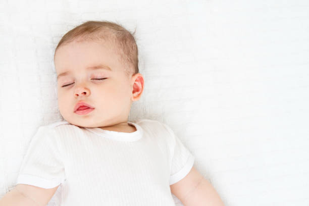 istock Beautiful sleeping baby on white background 810670402