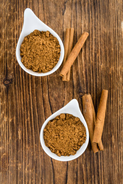 istock Portion of Cinnamon Powder on wooden background (selective focus) 810671878