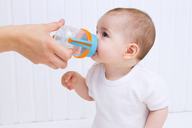 istock Beautiful baby drinking water from bottle 810675862