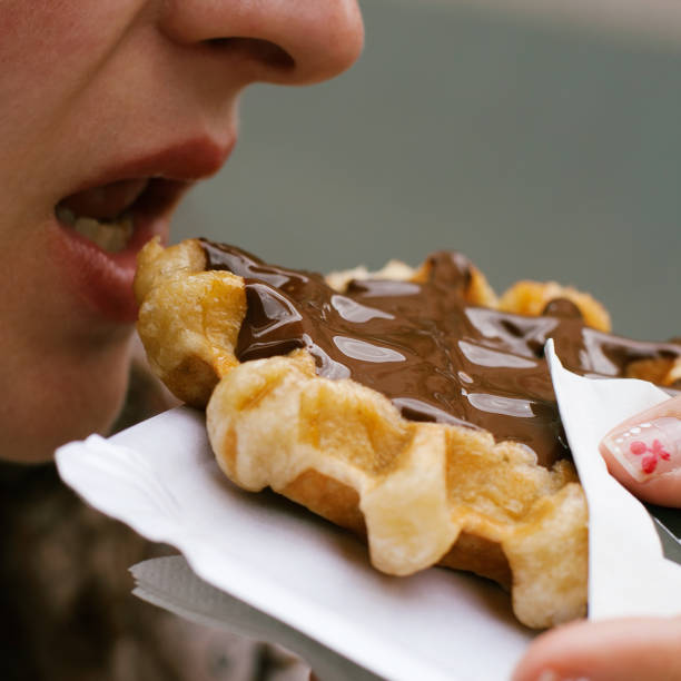 istock Girl eating waffle with chocolate. 810686890