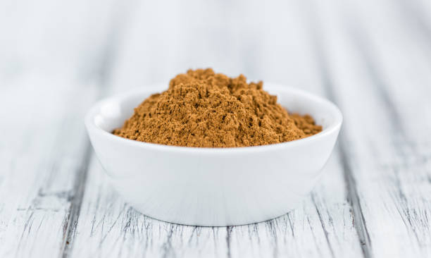 istock Portion of Cinnamon Powder on wooden background (selective focus) 810689222