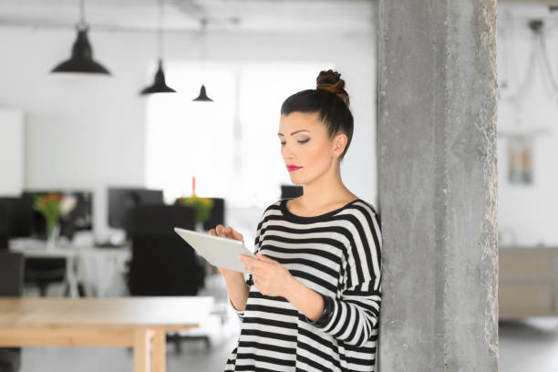 istock Creative young woman using a digital tablet in the office 810692934