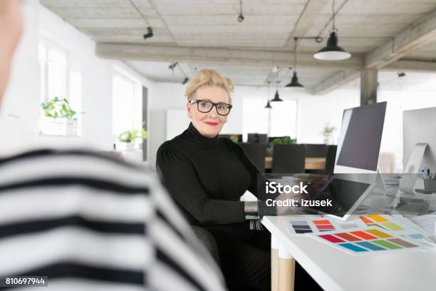Senior Businesswoman Using A Digital Tablet In The Office Stock Photo - Download Image Now
