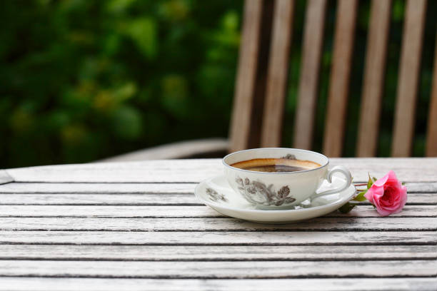 Outdoor photo of coffee cup with a flower a roses