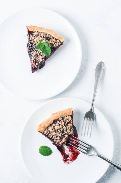 istock Portion of pie with jam on a white ceramic plate over a white concrete background 810711112