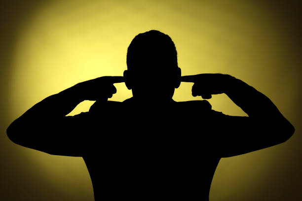 Silhouette of a man Profile of a  man closing his ears hands covering ears stock pictures, royalty-free photos & images