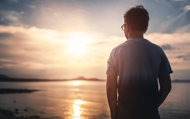istock Watching the sunset over sea 810717908