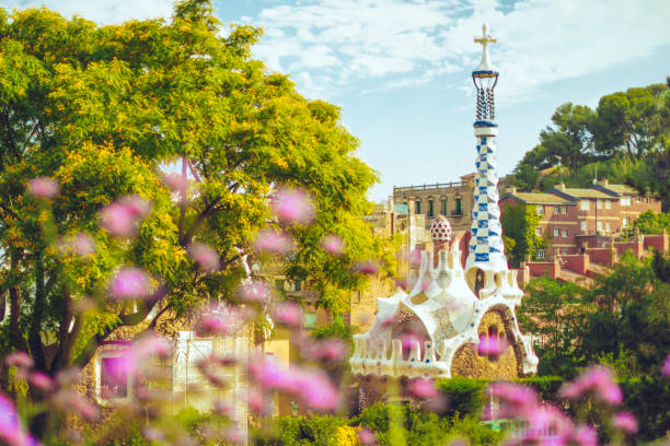 Beautiful sunrise in Barcelona seen from Park Guell. Park was built from 1900 to 1914 and was officially opened as a public park in 1926. In 1984, UNESCO declared the park a World Heritage Site
