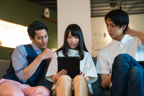 istock Three friends looking at a digital tablet together 810727226