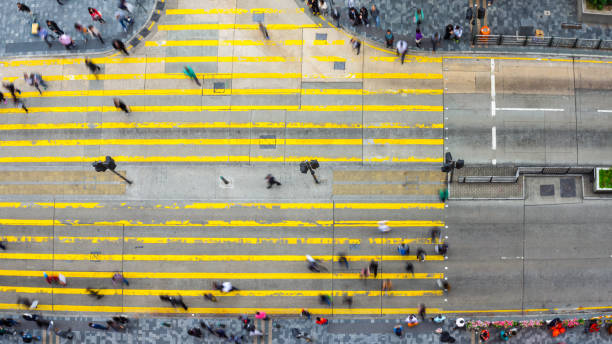 istock crowded people on road intersection in modern city 810736686