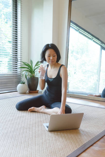 istock Asian woman working out at home 810736944