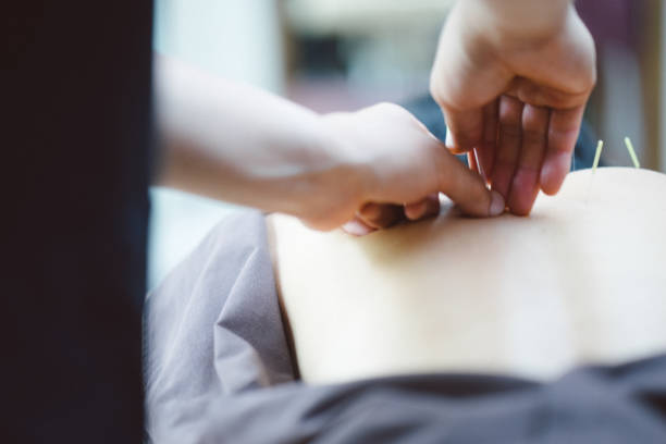 A masseur providing a hand massage to a client.