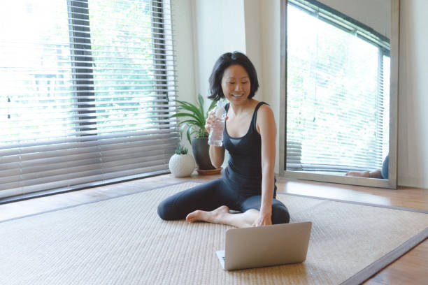 istock Asian woman working out at home 810747368